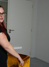 Glasses-wearing BBW posing and squeezing her boobies too