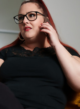 Glasses-wearing BBW posing and squeezing her boobies too